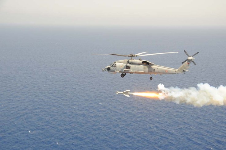 One Turkish Seahawk helicopter is firing a AGM-114 Penguin missile to LST Serdar.